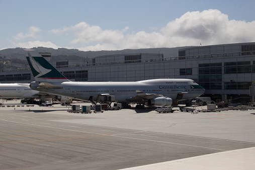 San Francisco, CA, USA - May 20, 2014 : Cathay Pacific Boeing 747-400 boarding and deplaning at San Francisco International (SFO).