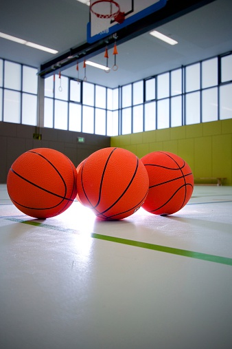 Basketballs in front of the basket with backlight