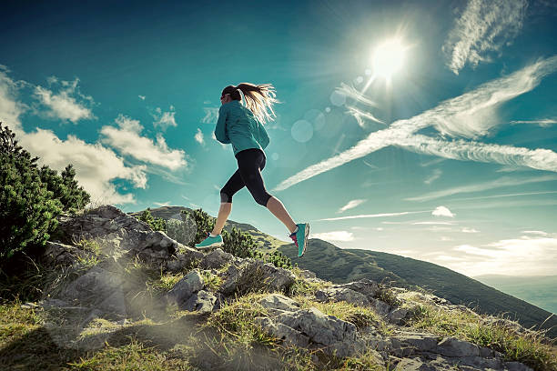 istock Female running in mountains under sunlight. 519262052