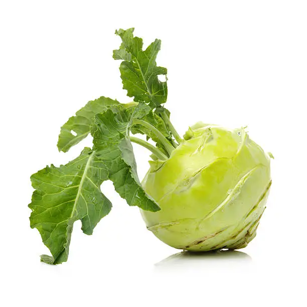 Fresh kohlrabi with green leaves on isolated white backround