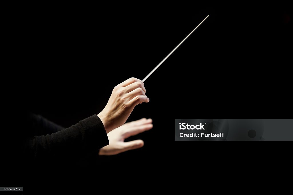 Hands of conductor Hands of conductor on a black background  Musical Conductor Stock Photo
