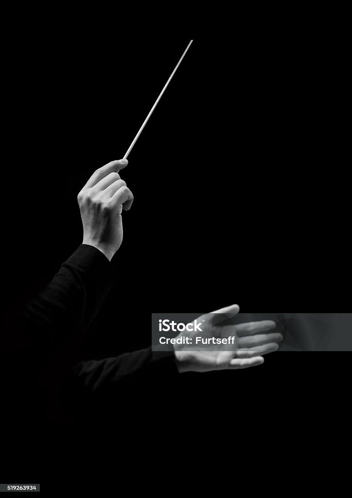 Hands of conductor on a black background Hands of conductor on a black background in black and white Musical Conductor Stock Photo