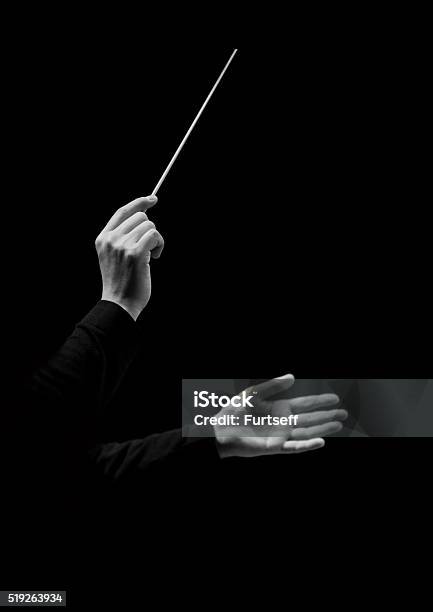 Hands Of Conductor On A Black Background Stock Photo - Download Image Now - Musical Conductor, Orchestra, Conductor's Baton