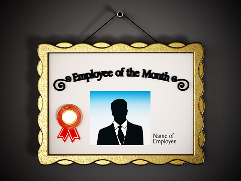 Employee of the Month signboard hanging on the wall.