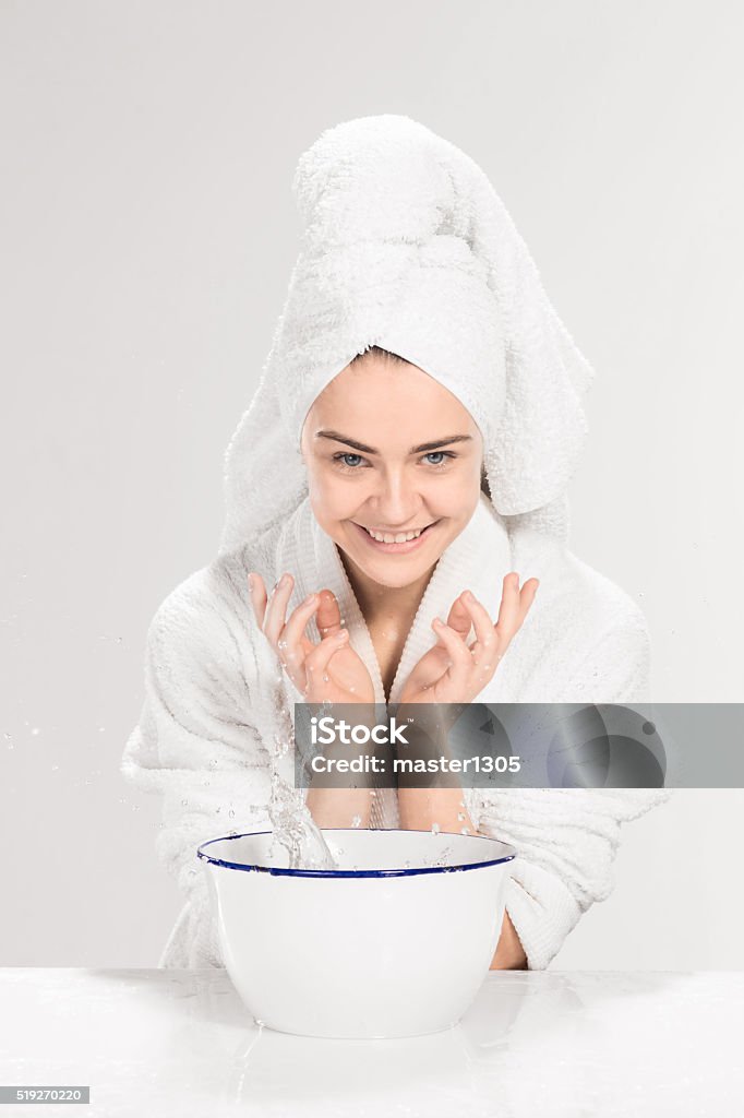 Young woman washing face with clean water The young woman washing face with clean water Adult Stock Photo