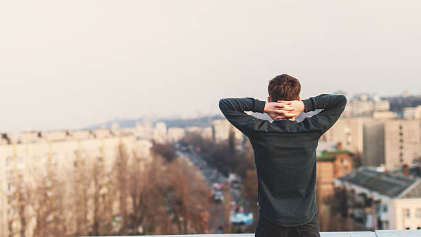 teenager standing on the roof