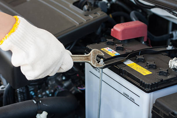 istock Hand with wrench repairing car engine 519272324