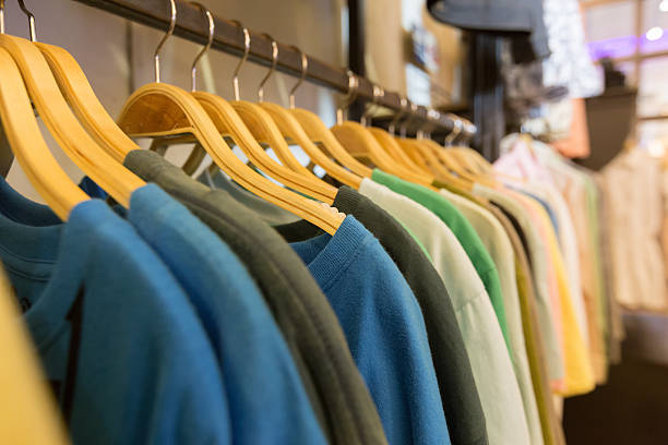 istock T-shirts hanging on wooden hangers. 519272406