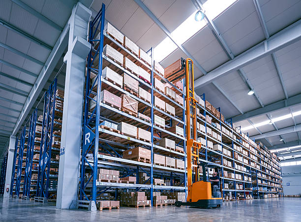 istock Forklift Lifting a cardboard box in warehouse aisle 519273518