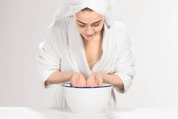 istock Young woman washing face with clean water 519274986