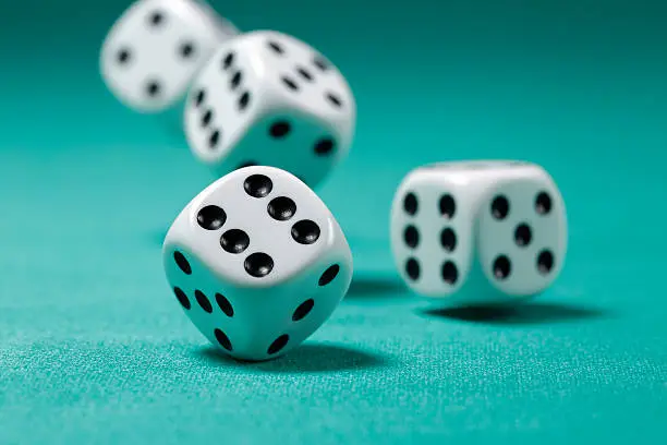 Photo of Rolling Dice on Felt Table