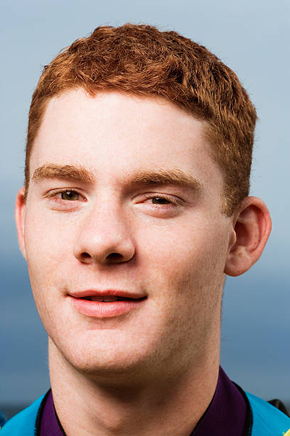 istock Young man smiling, portrait, close-up 519282073