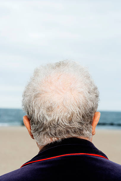 istock Senior man on beach, rear view, close-up 519282165