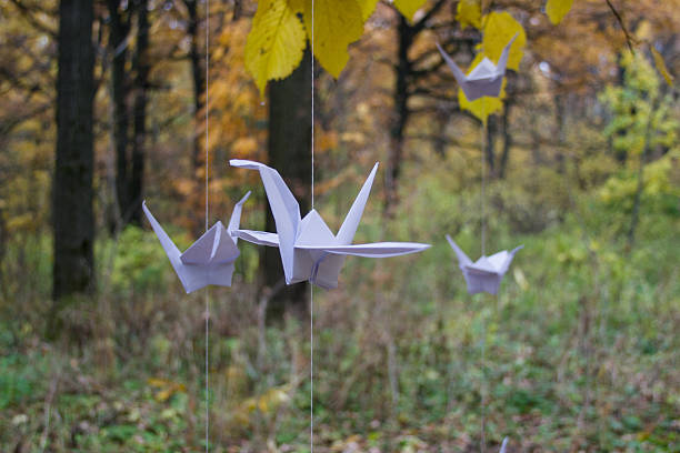 istock Paper crane in autumn Park 519283071