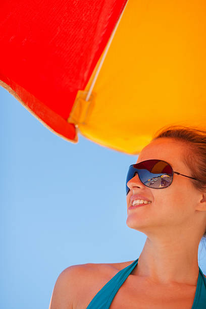 istock Happy woman in sunglasses on beach 519283235