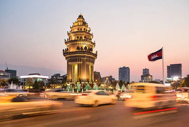 Traffic rush around the Independence monument, with its Khmer architecture style, in Phnom Penh, Cambodia capital city. Blurred motion archived with long exposure.