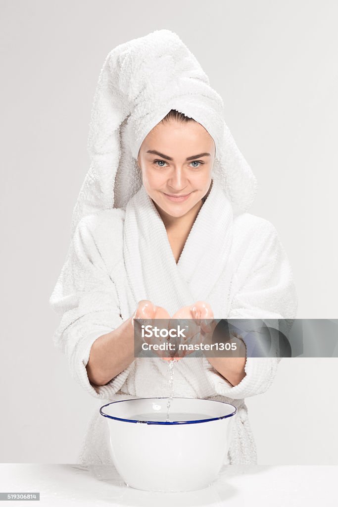 Young woman washing face with clean water The young woman washing face with clean water Adult Stock Photo