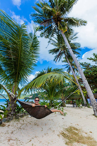 istock Girl in hummock on tropical beach 519307416
