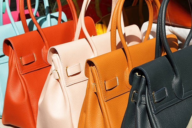 colorful leather handbags for sale vivid fine  leather handbags collection on San Lorenzo market in  Florence, Italy, Europe purse photos stock pictures, royalty-free photos & images