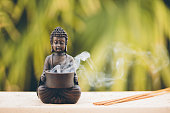 istock Buddha figurine with incense 519309598