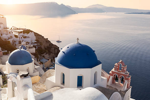 Sun on the blue domes in Oia stock photo