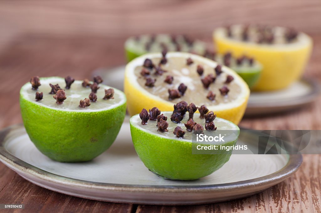 Lemon and limes with cloves, natural insect repellent Lemon and limes with cloves, natural insect repellent. Shallow dof Clove - Spice Stock Photo