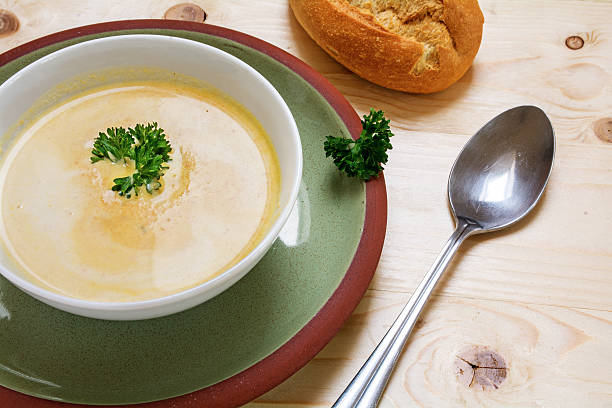istock cream soup with parsley in a bowl, green plate 519312810