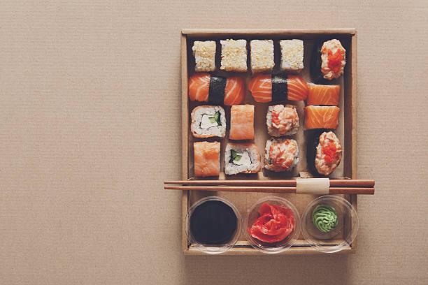 istock Set of sushi rolls at carton texture background 519314610