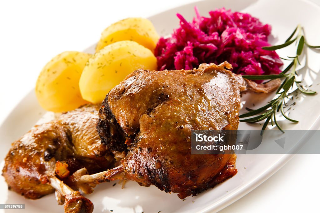 Roast duck thighs, boiled potatoes and red cabbage Duck with vegetables  Animal Body Part Stock Photo