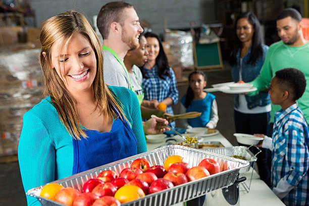 istock Woman holds tray of fruit in soup kitchen 519314834