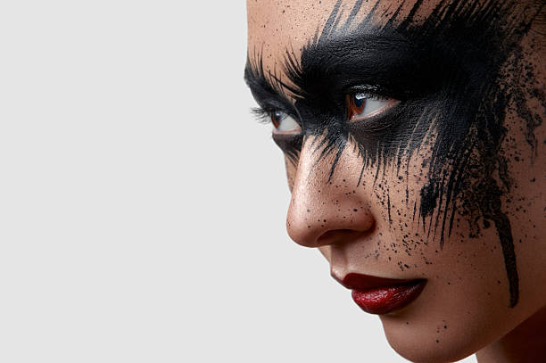 istock Female with Paint on Face looking at the Side 519316484