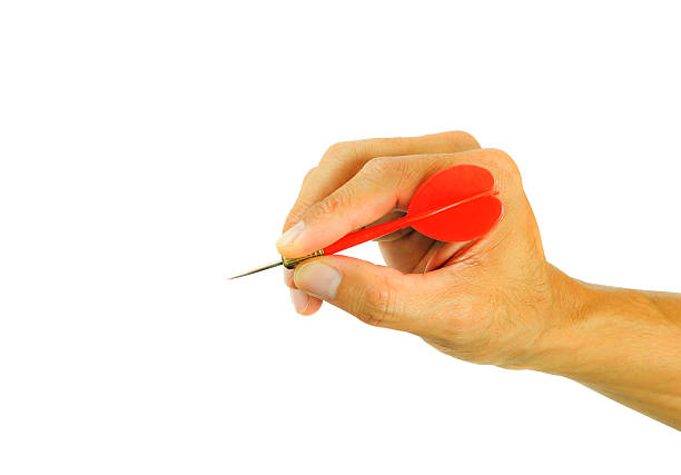 istock hand holding dart isolated on white background 519320412