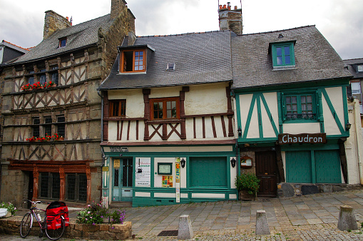 Dinan, France, September 8, 2023 - The historic clock tower (Tour de l'Horloge) in the medieval old town of Dinan, seen from Place Saint-Sauvier, Brittany, France.