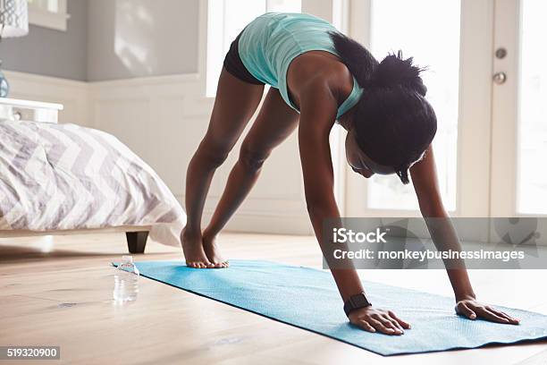Young Black Woman In The Downwardfacing Dog Yoga Pose Stock Photo - Download Image Now