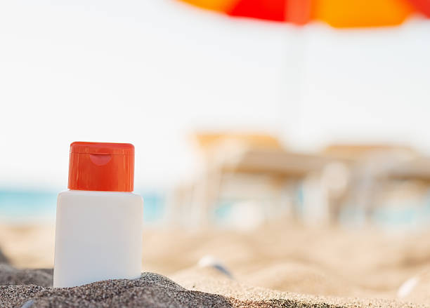 istock bottle of sun block creme in shadow on beach 519325739
