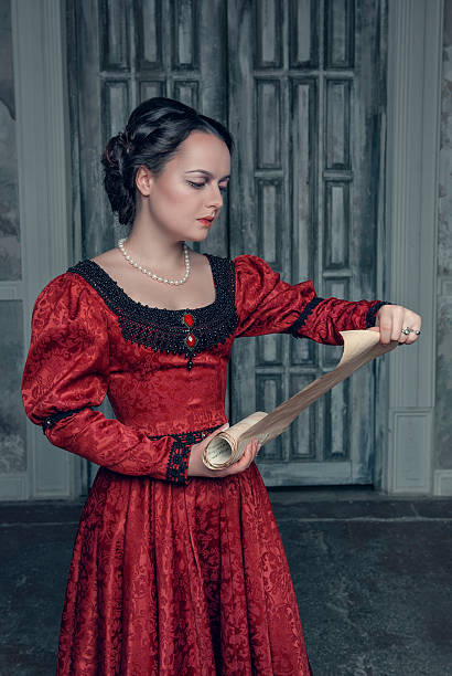 istock Beautiful woman in medieval dress with scroll letter 519325751