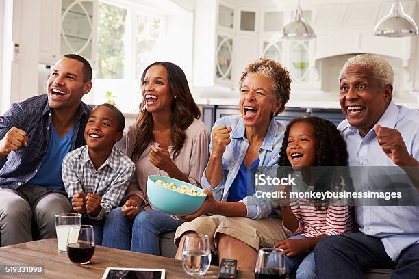 Multi Generation Black Family Watching Sport On Tv At Home Stock Photo - Download Image Now