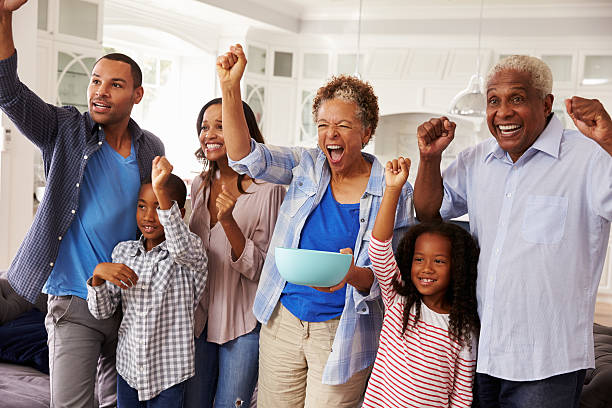 istock Multi generation black family watching sport on TV celebrate 519331116