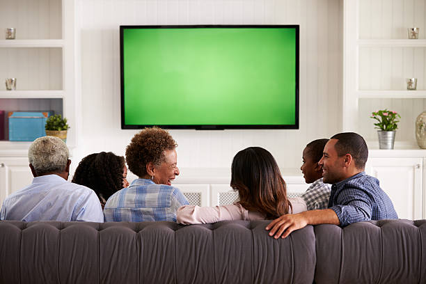 istock Multi generation family watching TV and laughing, back view 519331434