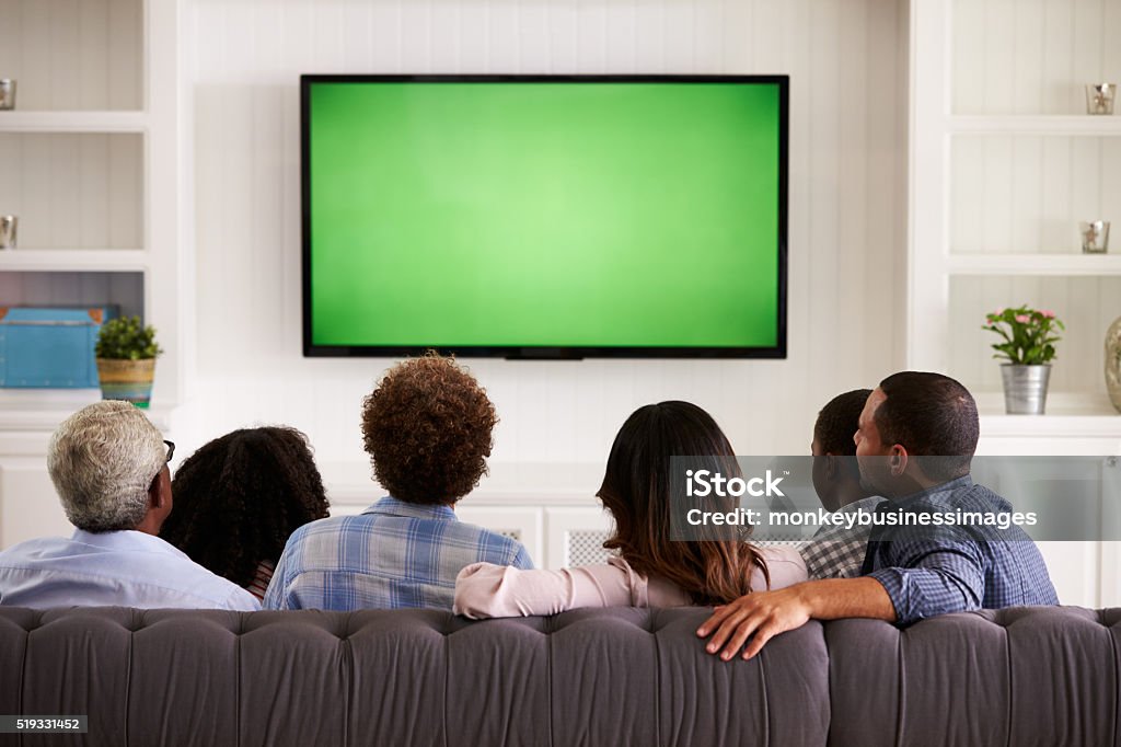 Multi generation family watching TV at home, back view Watching TV Stock Photo