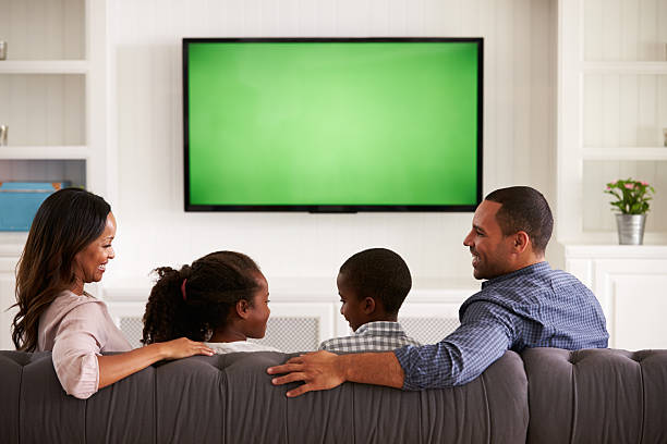 istock Parents and children watching TV, looking at each other 519331638