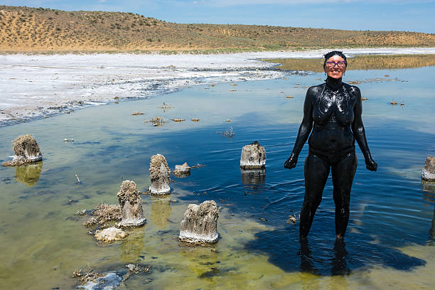 istock The woman accepts the curative mud baths on the lake Baskunchak. 519332004