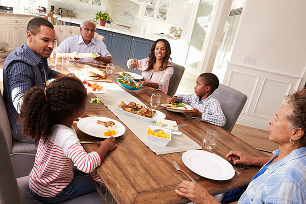 istock Multi generation black family serving a meal in the kitchen 519332218