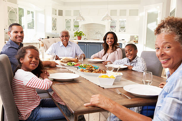 istock Multi generation black family at kitchen table for a meal 519332266