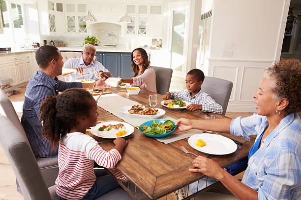 istock Multi generation black family serving a meal in the kitchen 519332422