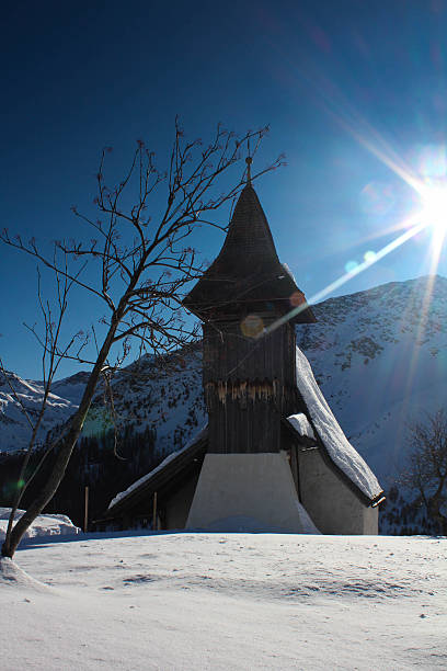 Mountain church built in 15th century in Arosa, Switzerland during a beautiful winter day