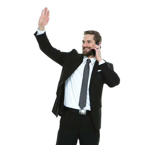 istock Smiling businessman waving hand while on phone 519338426