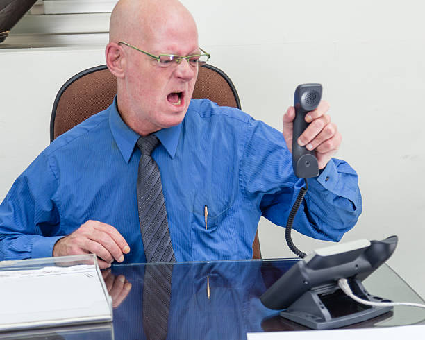 istock Businessman on phone at desk, angry 519338918