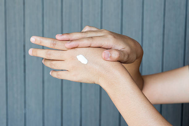 istock Young woman applying hands cream 519341156