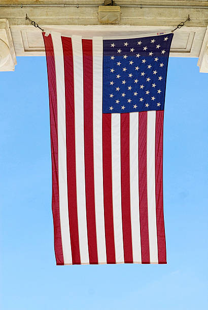 Close-up, U.S. Flag hanging at Arlington National Cemetery Arlington, Virginia, USA - May 24, 2015: The U.S. flag hangs in a light breeze at the Memorial Amphitheater at Arlington National Cemetery. memorial amphitheater stock pictures, royalty-free photos & images